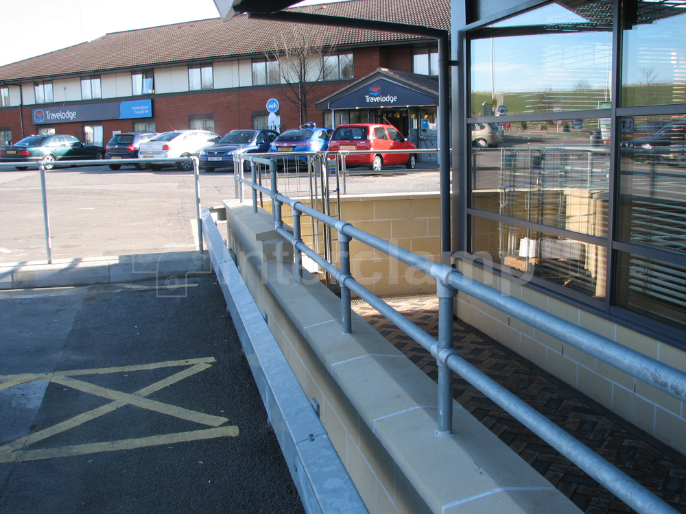 Interclamp galvanised double rail tube clamp guardrail constructed at a busy service station